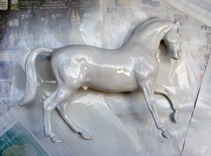 Do It Yourself of repainting Breyer model for home decor. Spraying multiple layers.