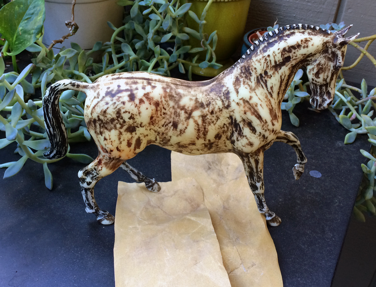 Do It Yourself of repainting Breyer model for home decor. Sanding old paint off model.